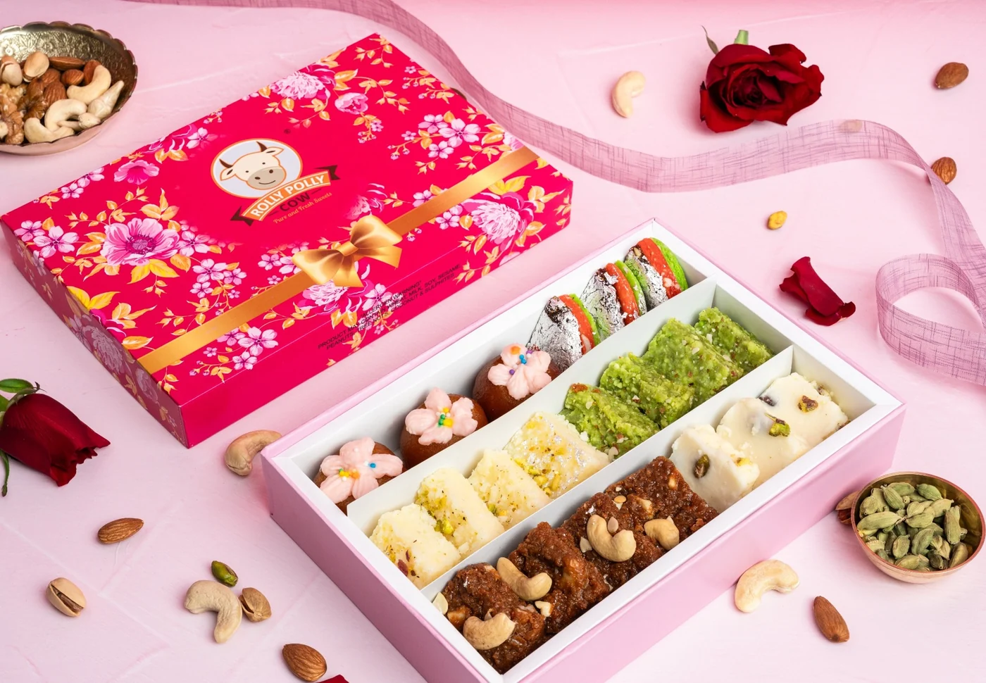 The floral Rolly Polly mixed sweets gift box, open to show rows of assorted mithai